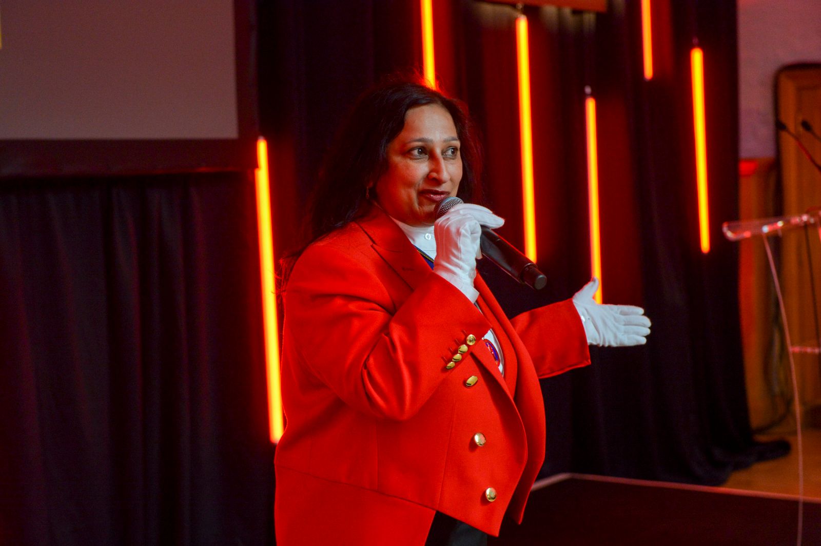Sonal in her Toastmaster uniform speaking on stage